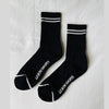 Black socks with white stripes and 'LE BON SHOPPE' branding on a light gray background