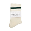 Pair of cream socks with green stripes and 'Le Bon Shoppe' label on a white background