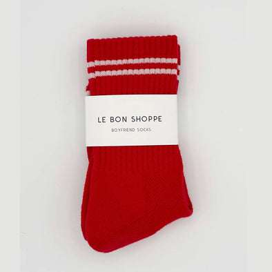 Red socks with white stripes on a white background, featuring 'Le Bon Shoppe' label.