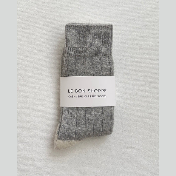 Pair of grey cashmere socks with 'Le Bon Shoppe' label on a light gray background