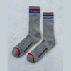 Gray socks with red and blue stripes on a light gray background