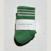 Green socks with white stripes on a light gray background, featuring 'Le Bon Shoppe' label.