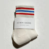 Pair of socks with red and blue stripes on a white background, featuring 'Le Bon Shoppe' label.