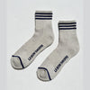 Pair of gray socks with blue stripes and 'Le Bon Shoppe' branding on a white background
