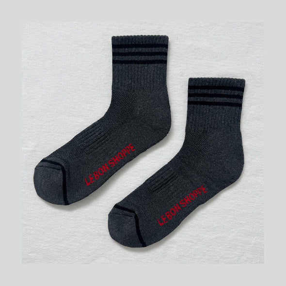 Pair of dark gray socks with red text on a light gray background