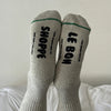 Gray socks with black text on a white surface