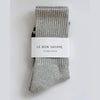 Gray socks with a white label on a light gray background