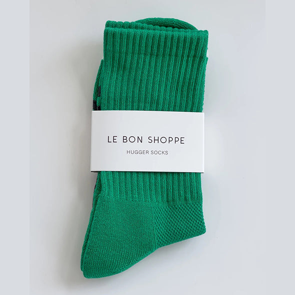 Green sock with 'Le Bon Shoppe' label on a light gray background