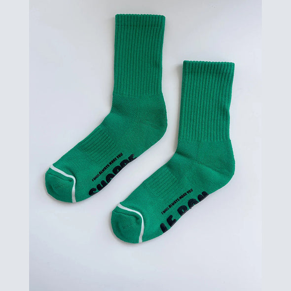 Pair of green socks with text on a white background