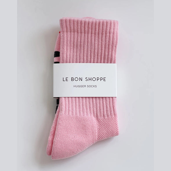 Pink socks with a white label on a light gray background