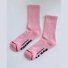 Pair of pink socks with text on a white background