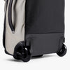 Close-up of a suitcase with wheels on a white background