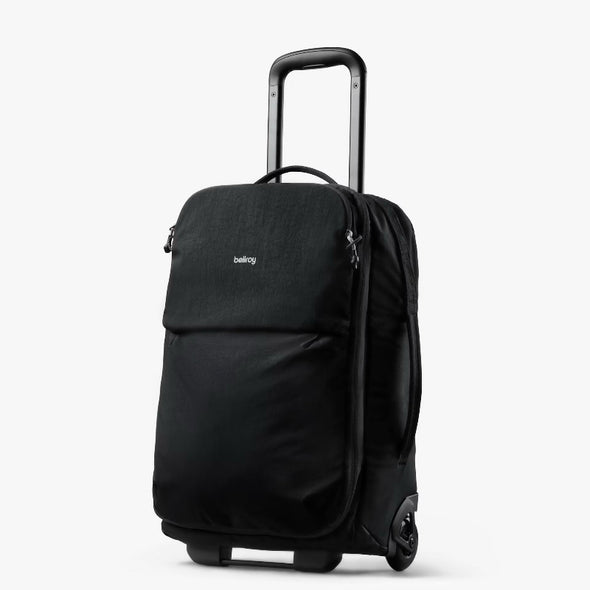 Black rolling suitcase with handle on a white background