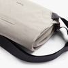 Ash crossbody bag with black strap on a white background, featuring the brand 'bellroy'.