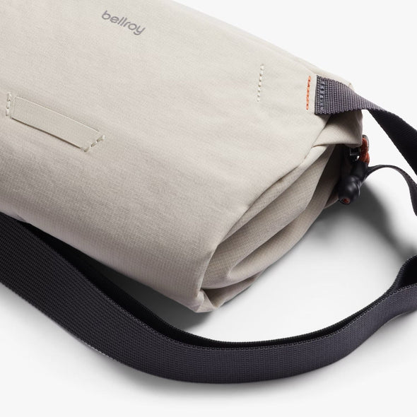 Ash crossbody bag with black strap on a white background, featuring the brand 'bellroy'.