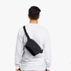 Person wearing a black crossbody bag from different angles on a white background
