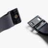 Black belt with plastic buckle on a white background