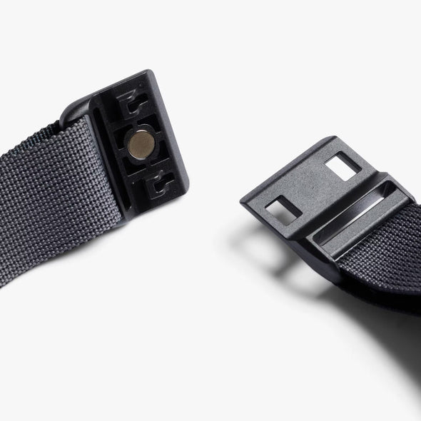 Black belt with plastic buckle on a white background