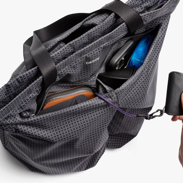 Gray backpack with items inside on a white background