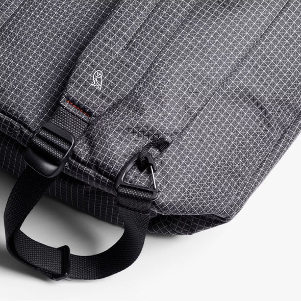 Gray checkered bag with black straps on a white background