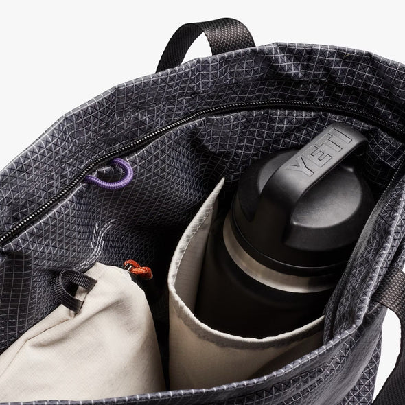 Bellroy Gray Totepack with a YETI brand water bottle inside on a white background