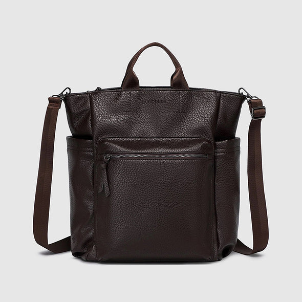 Brown leather backpack with a shoulder strap on a light gray background