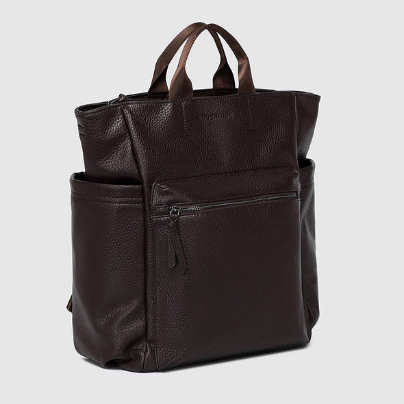 Brown leather backpack on a light gray background