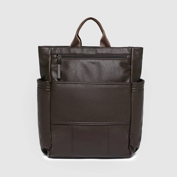 Brown leather backpack on a light gray background