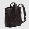 Brown leather backpack on a light gray background