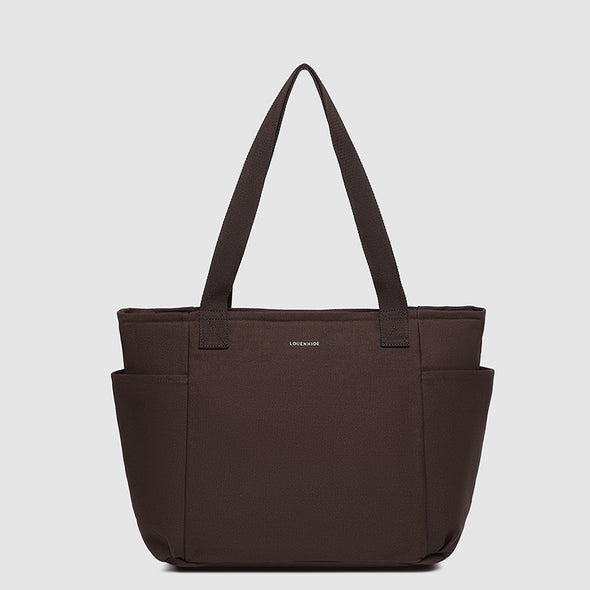Brown tote bag with a visible brand logo on a light gray background