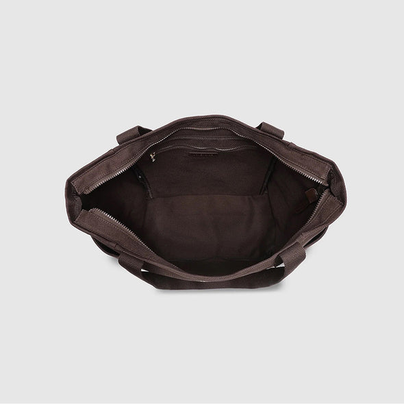 Brown leather duffel bag on a light gray background