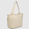 Beige tote bag with a visible brand logo on a light gray background