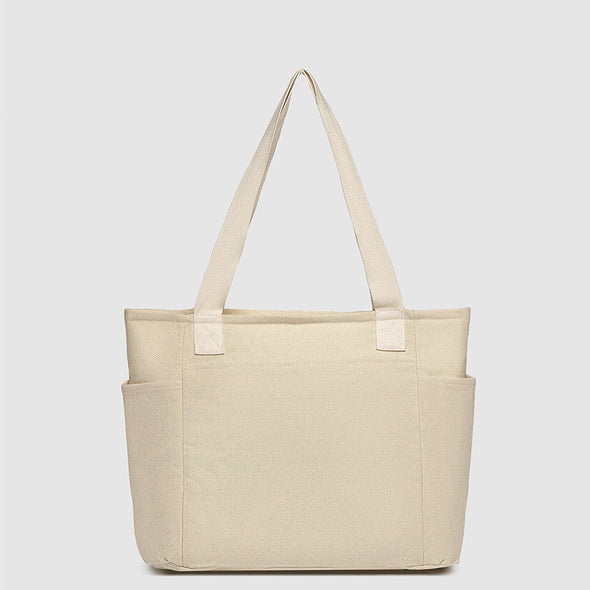 Beige tote bag with straps on a light gray background