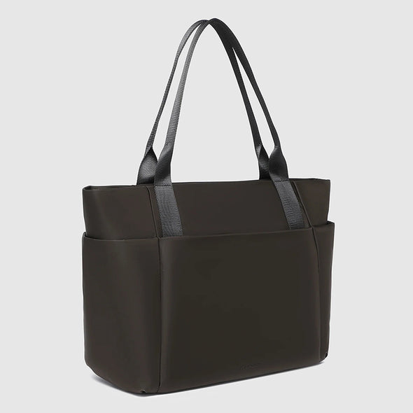 Black tote bag with black handles on a light gray background