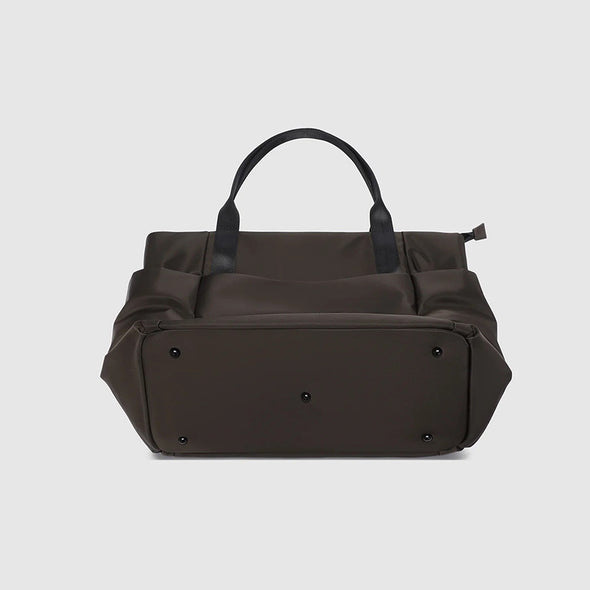 Brown leather duffel bag on a light gray background