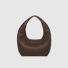 Brown leather handbag on a light gray background