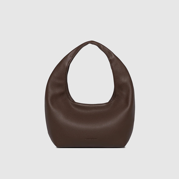 Brown leather handbag on a light gray background