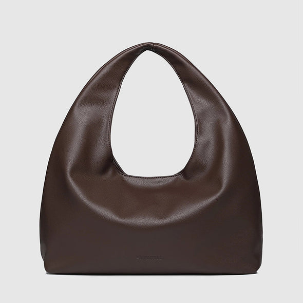 Brown leather handbag on a light gray background