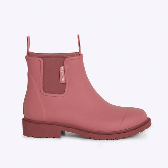 Pink rain boot with a visible brand logo on a light gray background