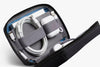 Zipped travel case with electronic accessories on a white background