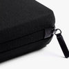 Tech Kit by Bellroy Black fabric bag with zipper and handle on a white background