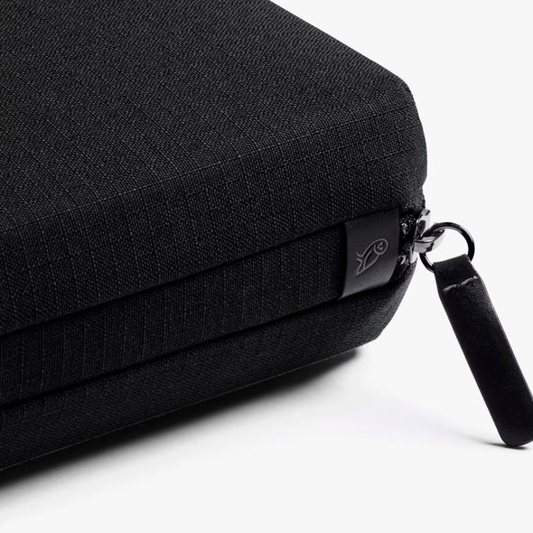 Tech Kit by Bellroy Black fabric bag with zipper and handle on a white background