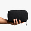 Tech Kit by Bellroy in black held by a hand on a white background