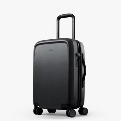 Black suitcase with wheels and handle on a white background