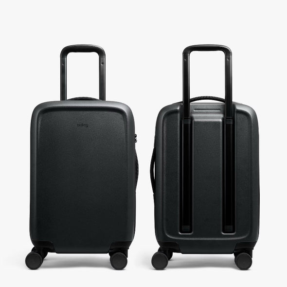 Two black suitcases on a white background