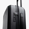 Black suitcase with a combination lock on a white background