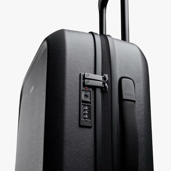 Black suitcase with a combination lock on a white background