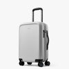Silver suitcase with wheels and handle on a white background