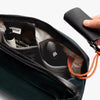 Venture Travel Crossbody by Bellroy Deep Ocean with personal items and a key fob on a white background