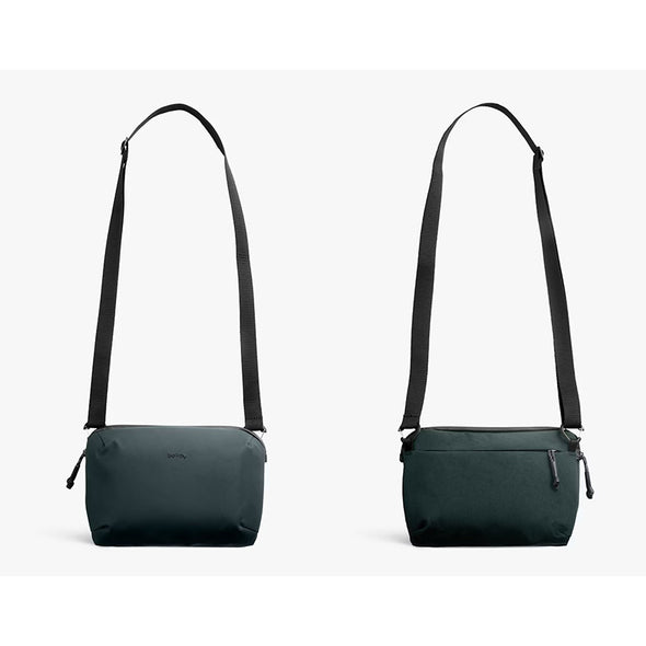 Two dark green shoulder bags with black straps on a light gray background